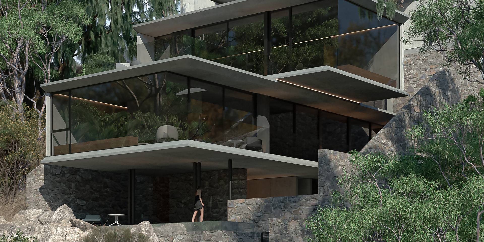 Casa escalonada de concreto y cristal integrada a un terreno con rocas y vegetación